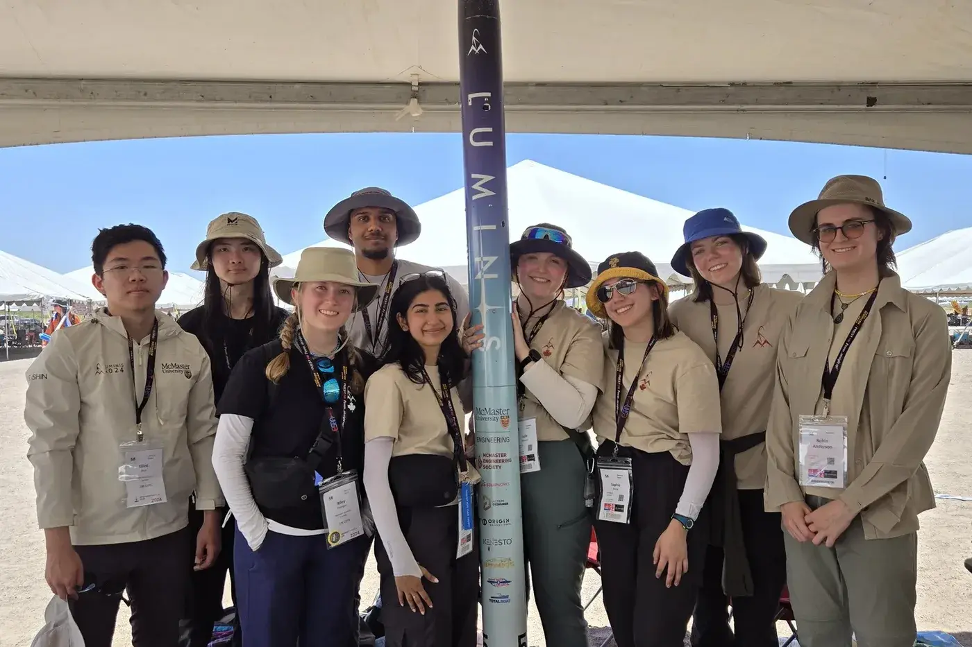 The Luminis team poses with the completed airframe under the range tent, LUMINIS lettering and bib 58 visible.
