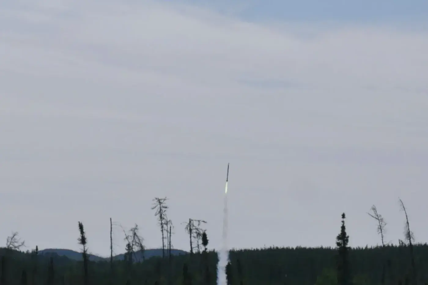 Luminis V2 clears the pad at Launch Canada, exhaust plume trailing behind the ascending airframe.