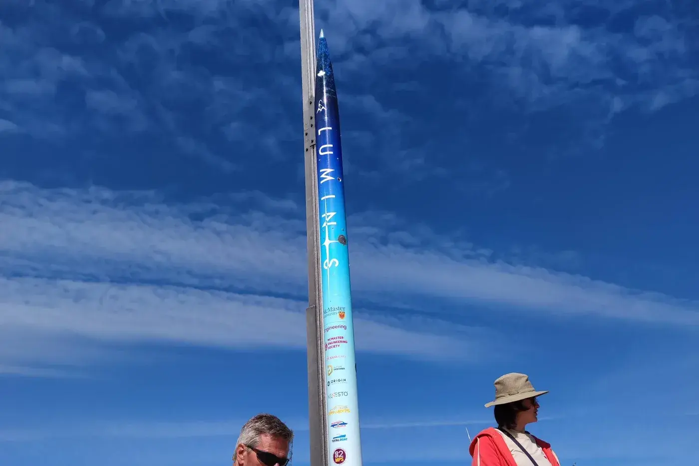 Luminis V2 stands vertical on the launch rail before flight, LUMINIS lettering and bib 13 readable up the airframe.
