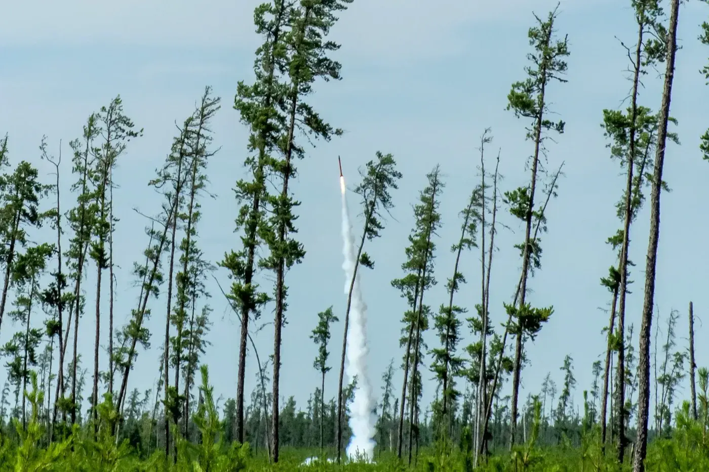 A rocket leaves the pad with a visible exhaust plume at Launch Canada 2022.