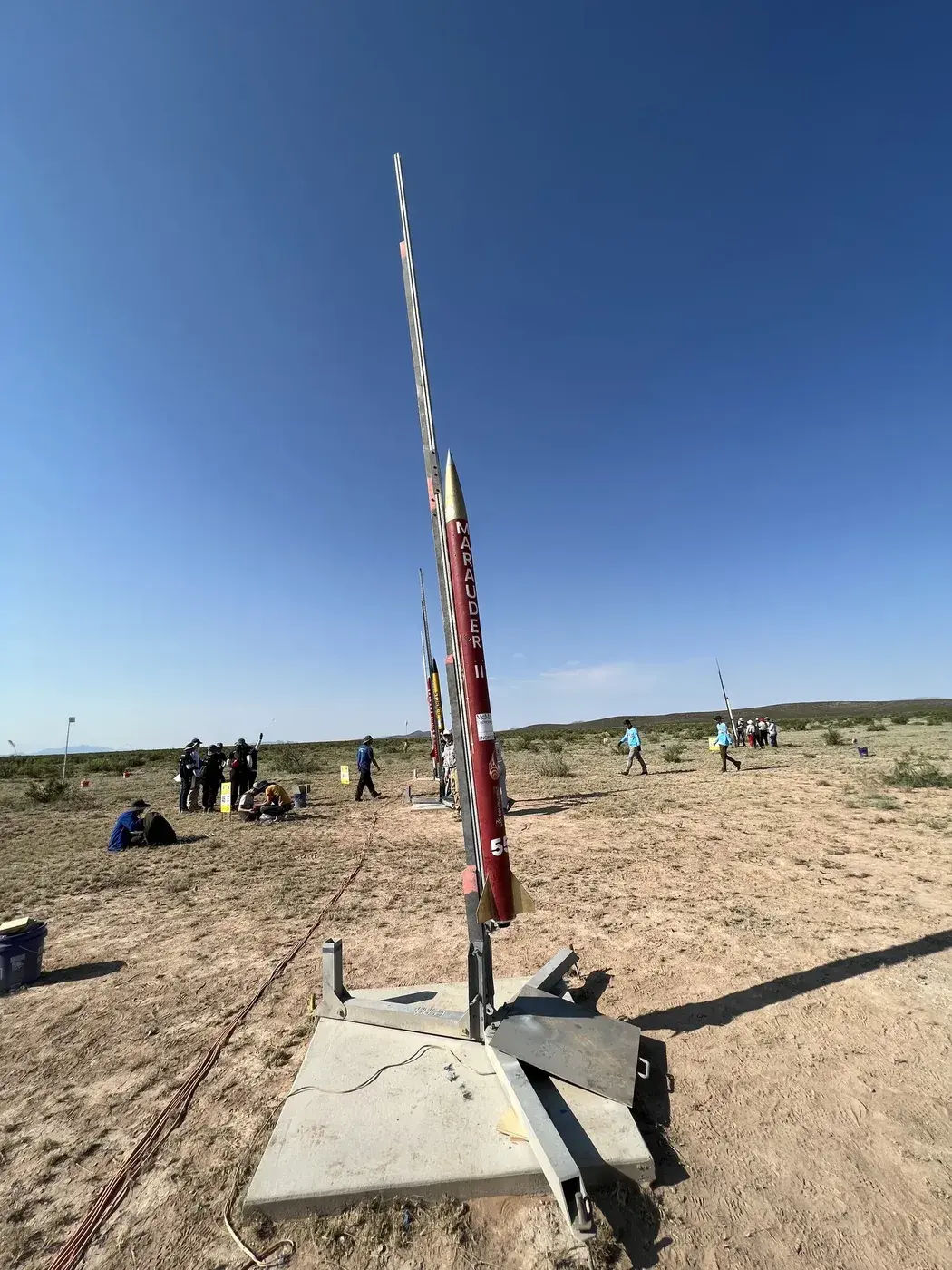 Marauder II stands vertical on the desert launch rail, bib 55.