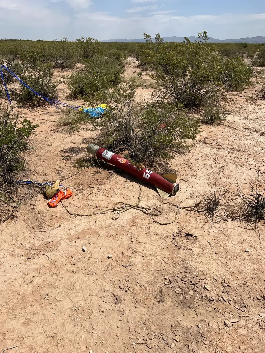 The recovered Marauder II airframe lies on the desert floor after landing.