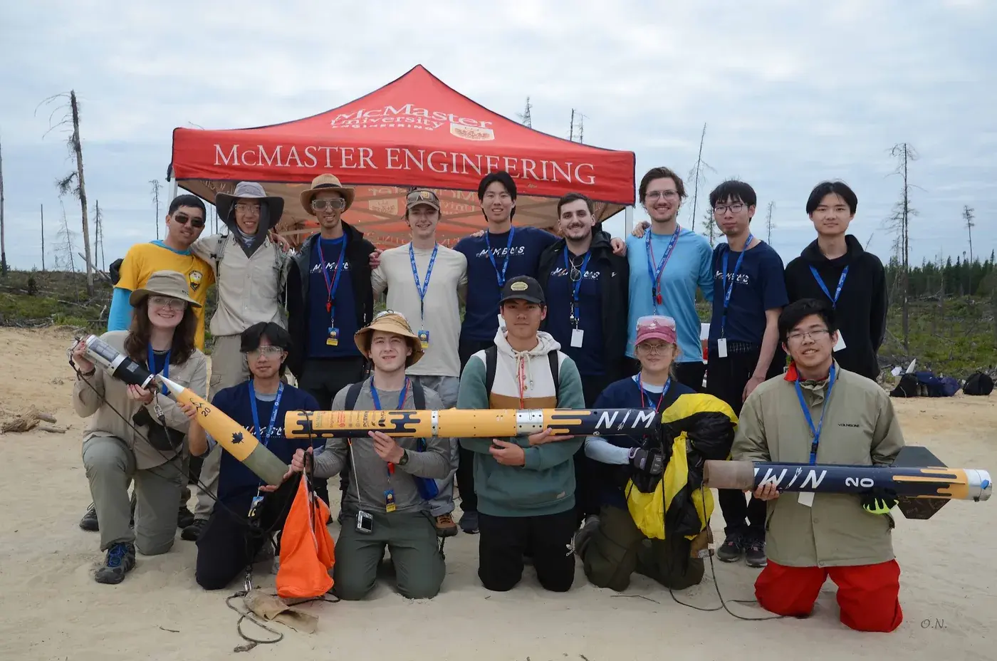 The Nimbus team with disassembled airframe sections under the McMaster Engineering tent at Launch Canada 2025, NIMBUS lettering visible.