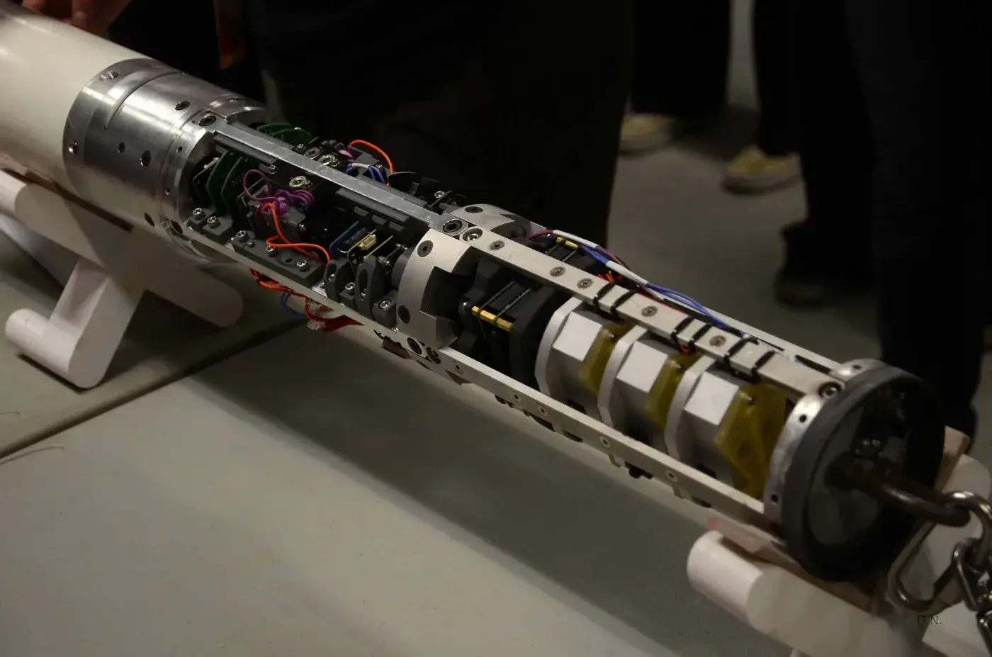 The open airframe before final assembly: left to right, the airbrake actuator, the avionics bay, and the payload section.