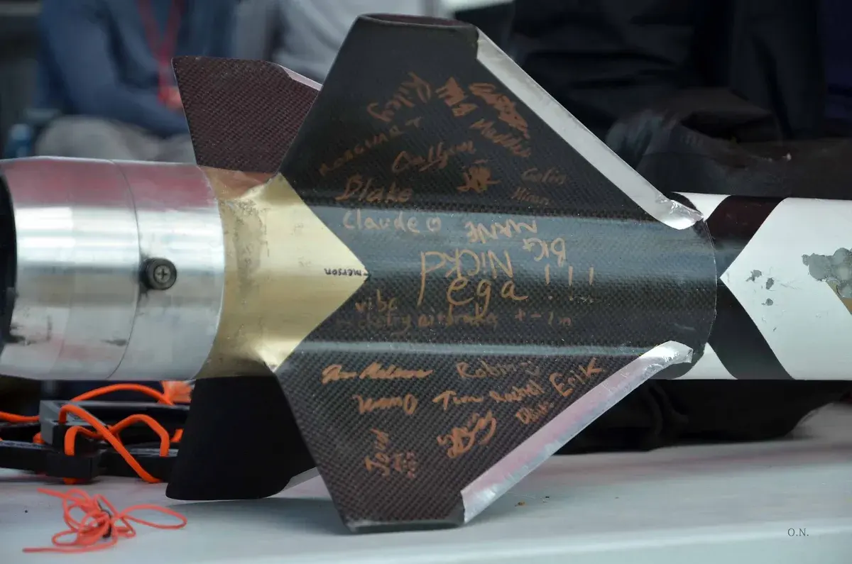 Osiris carbon-fibre fins covered in gold team signatures on the competition table.